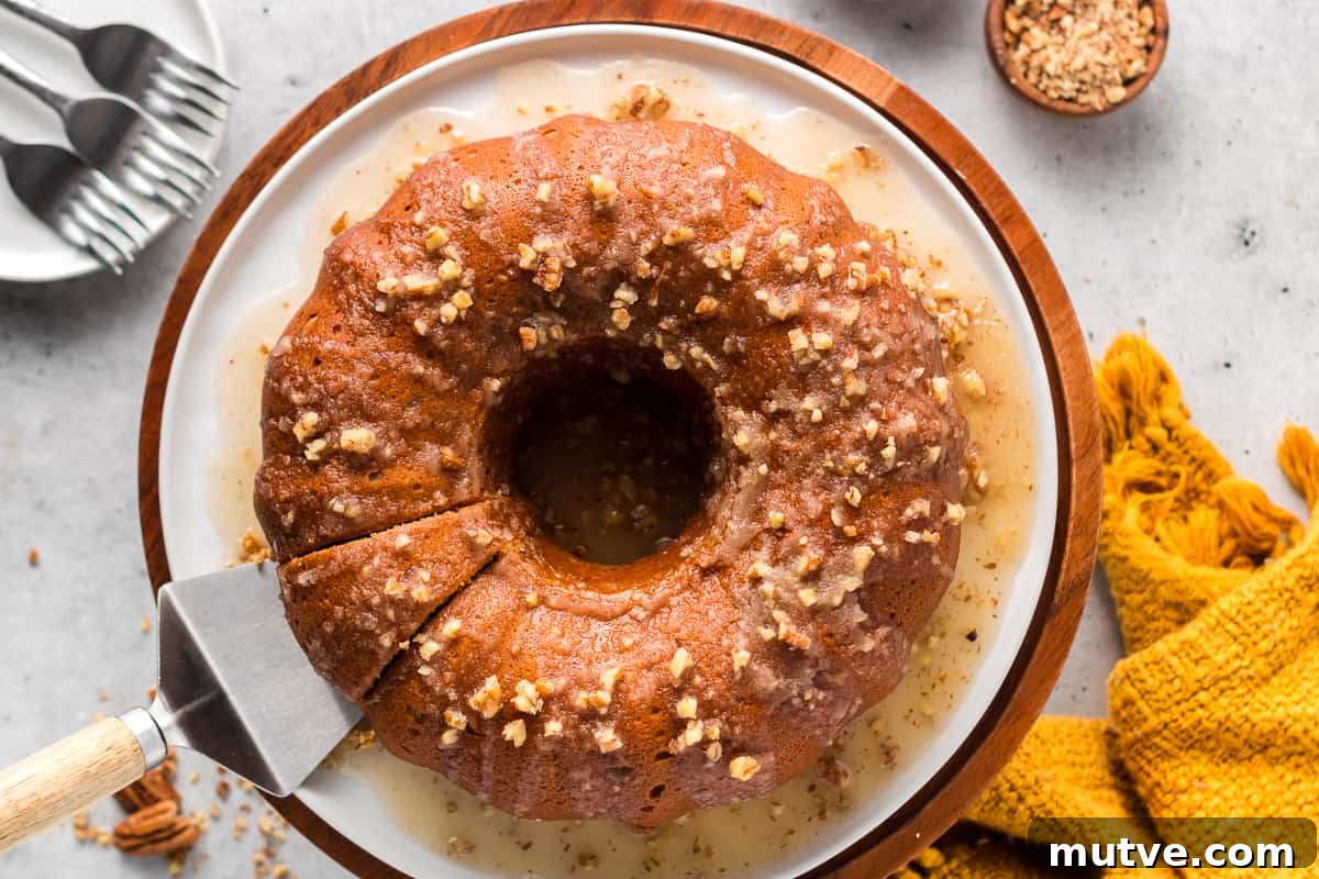 Spiced Sweet Potato Bundt Cake with Maple Glaze 5 A top down shot of a spatula resting under a slice of bundt cake on a platter.