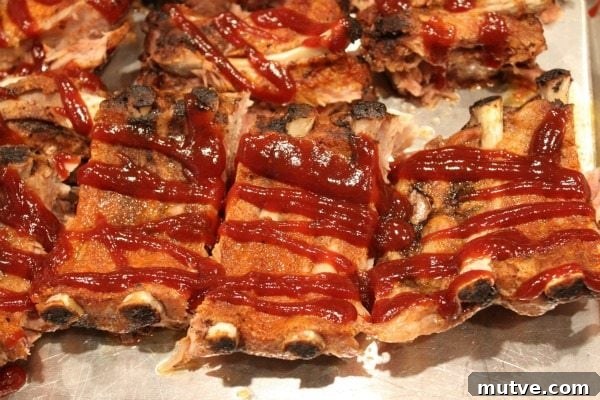Making Ribs in the Oven ribs drizzled with sauce