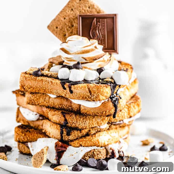 stack of marshmallow filled graham cracker French toast topped with chocolate, marshmallows and graham crackers