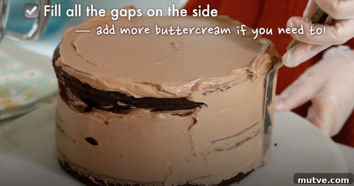 How to Frost a Cake: Step-by-Step for Smooth Icing 11 crumb coating the side of the whole cake