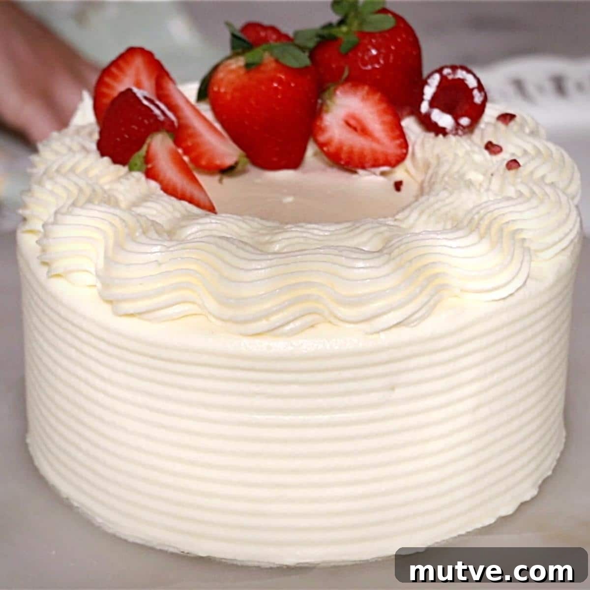 How to Frost a Cake: Step-by-Step for Smooth Icing 4 a whole cake frosted with cream cheese buttercream