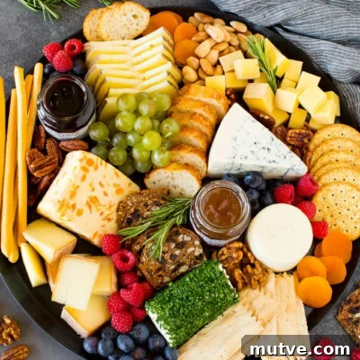 The best cheese board with assorted cheeses, bread, crackers, fruit and nuts.