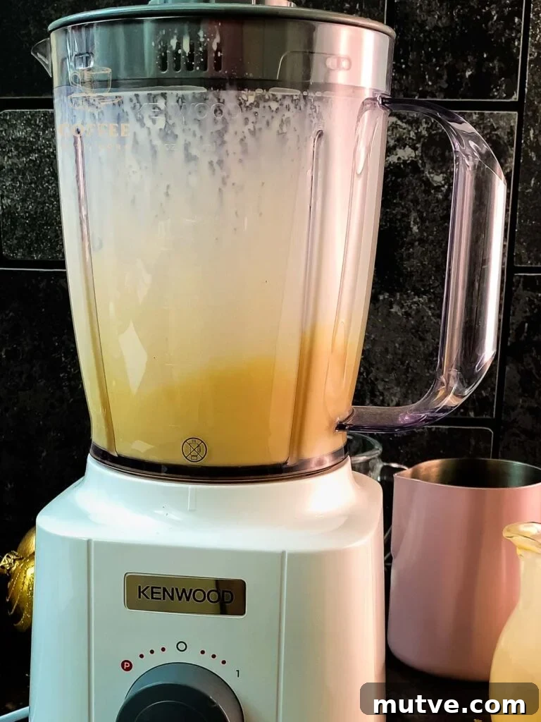 Blend the eggnog with the milk using a blender.
