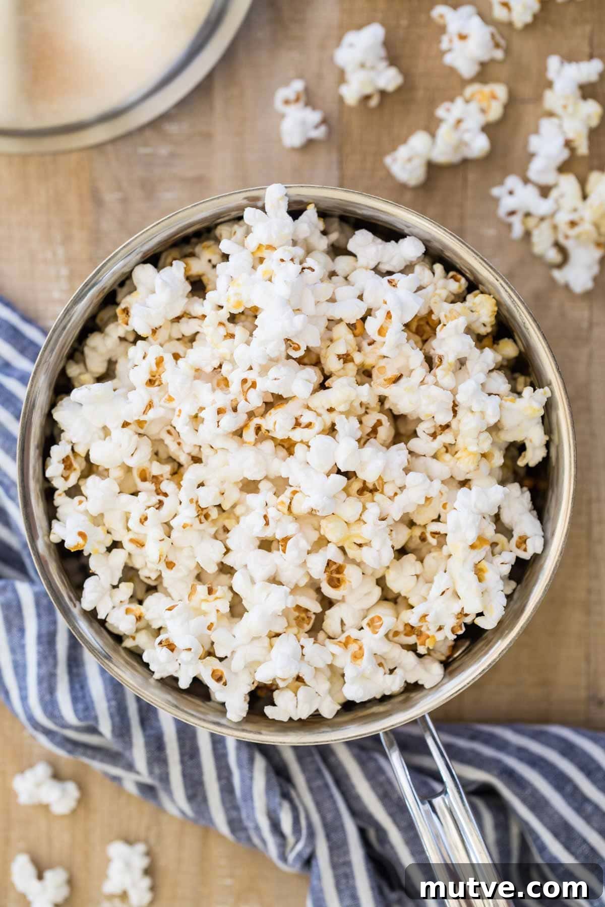 silver saucepan full of kettle corn