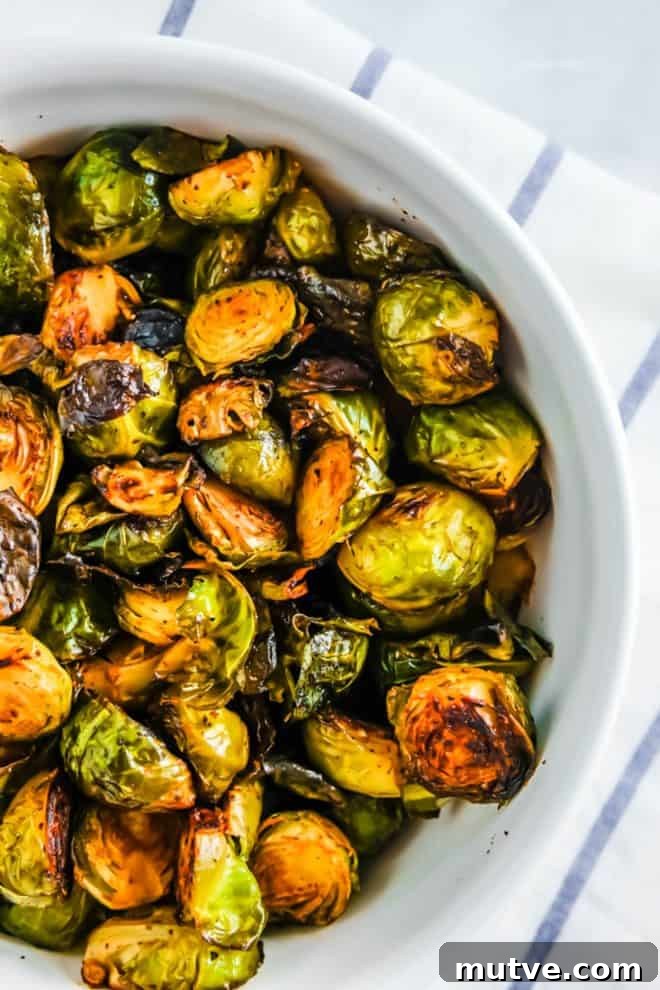 Crispy Roasted Brussels Sprouts with Balsamic Glaze 6 baked brussels sprouts in a white bowl