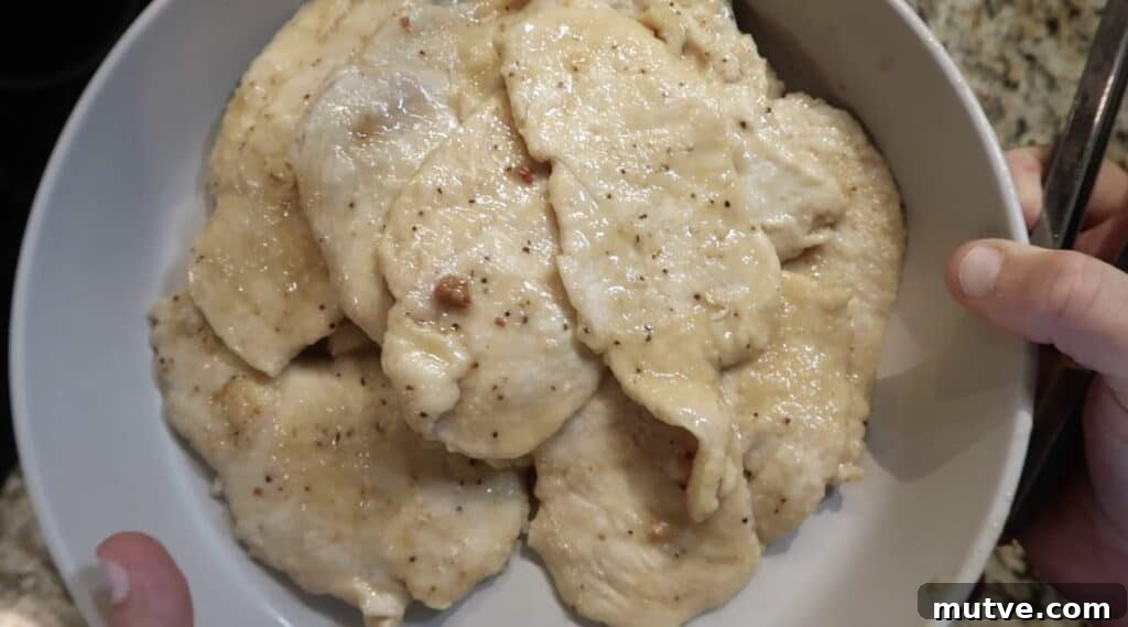 Creamy Instant Pot Chicken Baconara Pasta 20 Cooked chicken transferred to a serving dish.