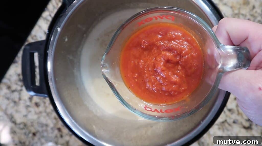 Creamy Instant Pot Chicken Baconara Pasta 24 Adding marinara to sauce
