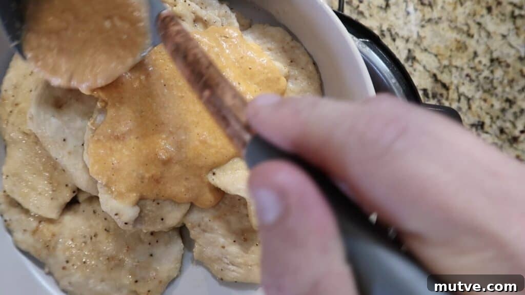Creamy Instant Pot Chicken Baconara Pasta 27 Lading sauce over chicken