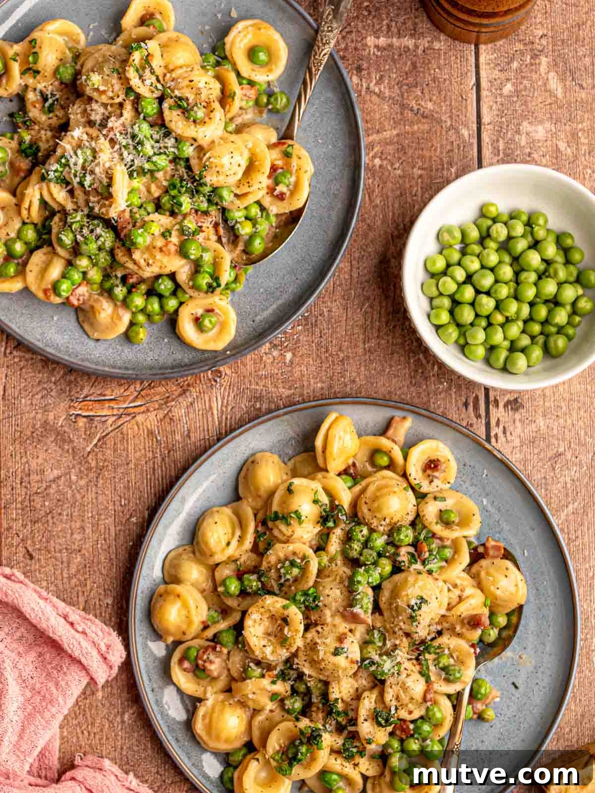 Plates of pasta with peas and pancetta.