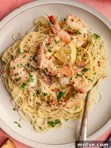 A plate of spaghetti and shrimp scampi.