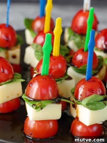 Chicken Tortilla Pinwheels Recipe: Cheesy Party Appetizer 16 caprese bites on a black platter