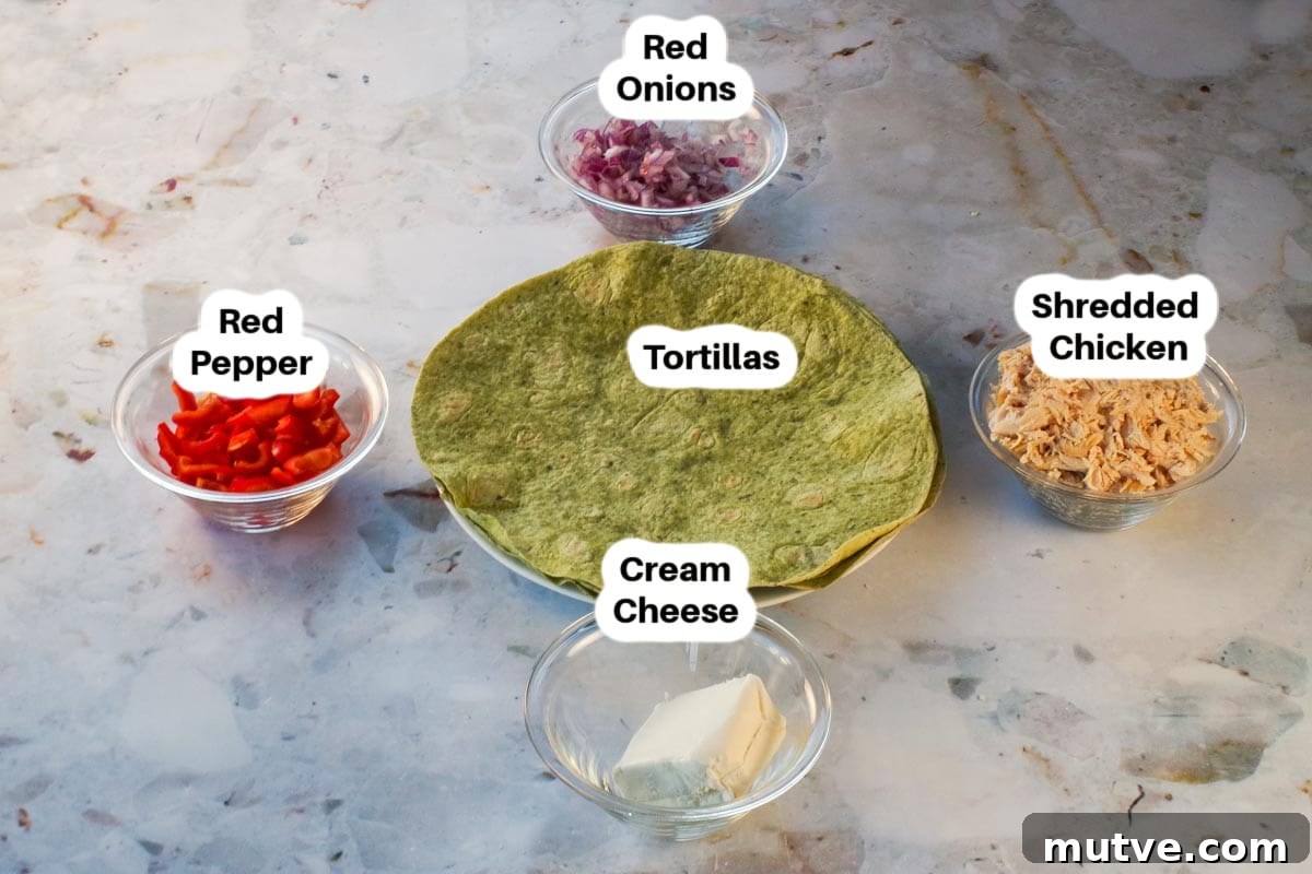 Chicken Tortilla Pinwheels Recipe: Cheesy Party Appetizer 4 ingredients needed for chicken pinwheels in glass bowls, labelled, with tortillas in the middle.