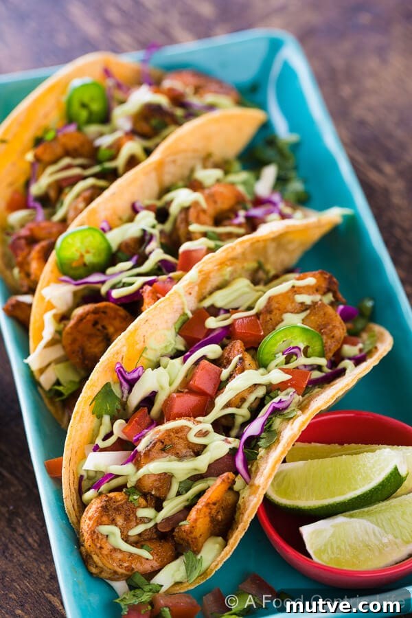 Baja Shrimp Tacos: Grilled or Stovetop 5 Spicy grilled shrimp tacos on a plate.
