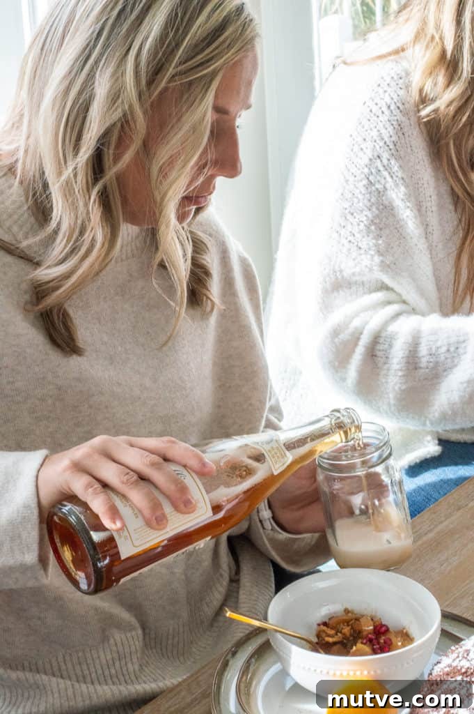 Lady pouring apple cider at Hygge Christmas breakfast