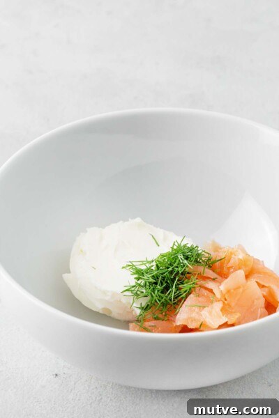 Smoked Salmon Tea Sandwiches Recipe with Cream Cheese and Dill 5 Smoked salmon, cream cheese, and dill in a white bowl.