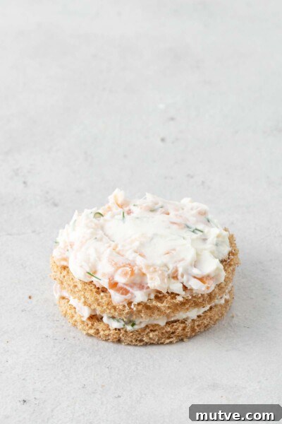 Smoked Salmon Tea Sandwiches Recipe with Cream Cheese and Dill 8 Bread cut into circles with layers of smoked salmon spread.