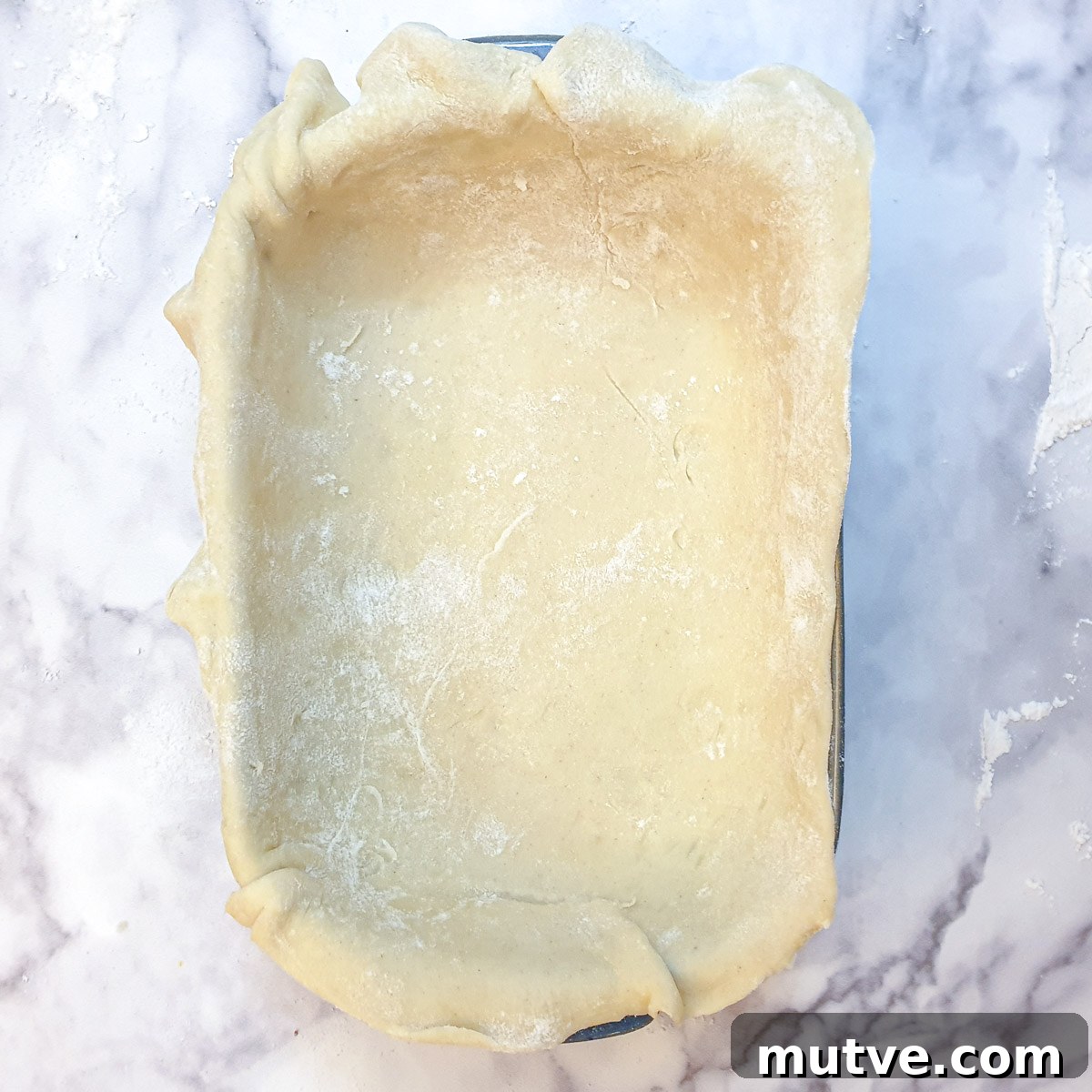 A baking dish lined with pastry.