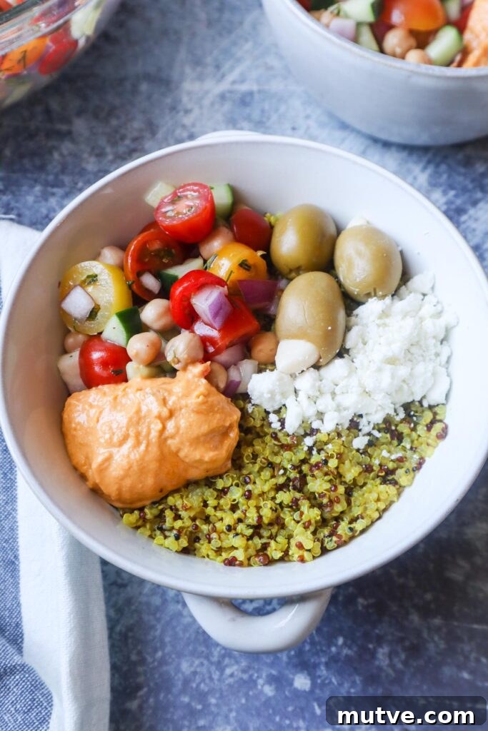 Mediterranean Power Bowl Recipe with Chickpeas and Tahini 3 white bowl with quinoa, feta, olives, hummus, and tomato cucumber salad