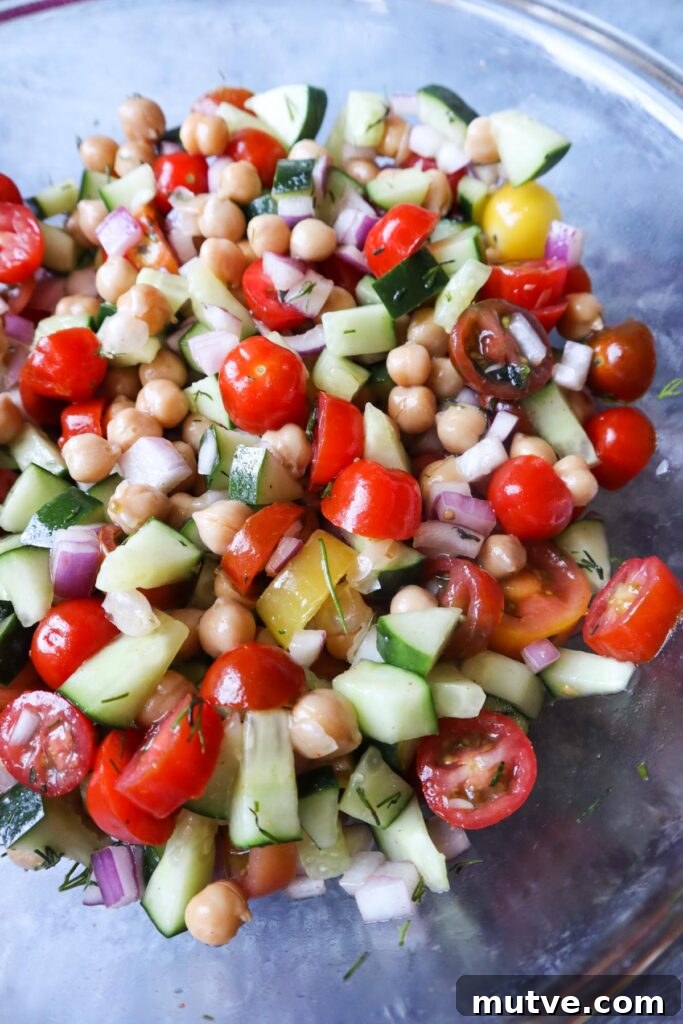 Mediterranean Power Bowl Recipe with Chickpeas and Tahini 5 glass bowl with cucumbr tomato salad with fresh dill, red onion, and garbanzo beans