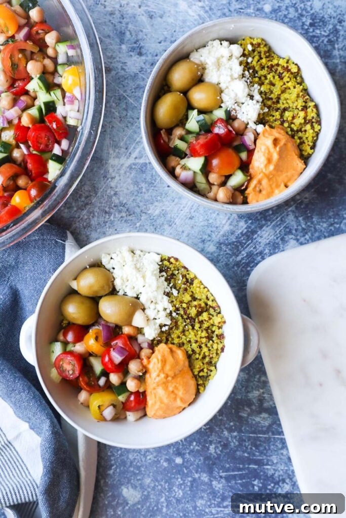 Mediterranean Power Bowl Recipe with Chickpeas and Tahini 6 two white bowls with mediterranean power bowls topped with tomato cucumber salad, olives, feta, and hummus