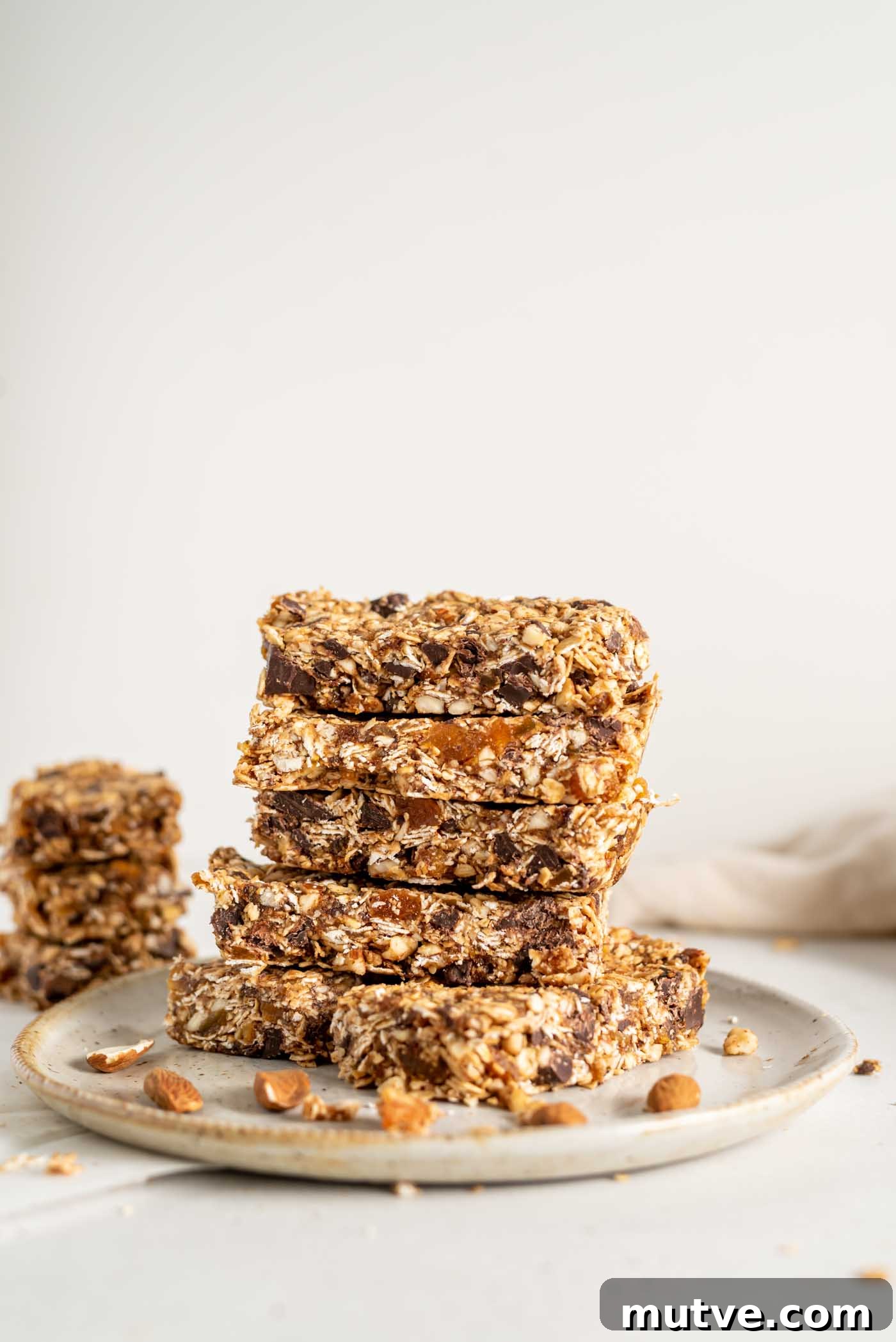 Homemade Apricot Muesli Granola Bars 2 A stack of homemade granola bars on a plate.