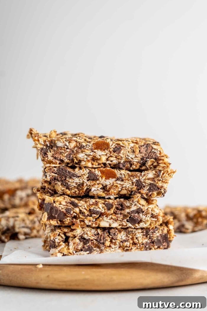 Homemade Apricot Muesli Granola Bars 11 A stack of homemade granola bars on a cutting board.