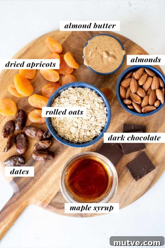 Homemade Apricot Muesli Granola Bars 3 Labelled ingredients for making granola bars, in containers on a cutting board.