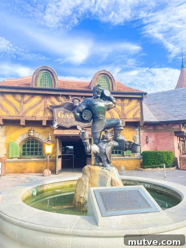 Gaston and LeFou statue fountain outside of Gaston's Tavern.