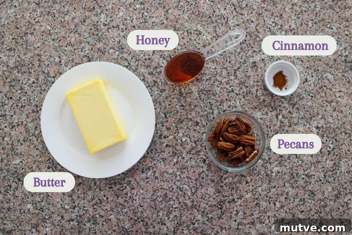 Labeled ingredients on a kitchen counter: butter, honey, pecans, and cinnamon.