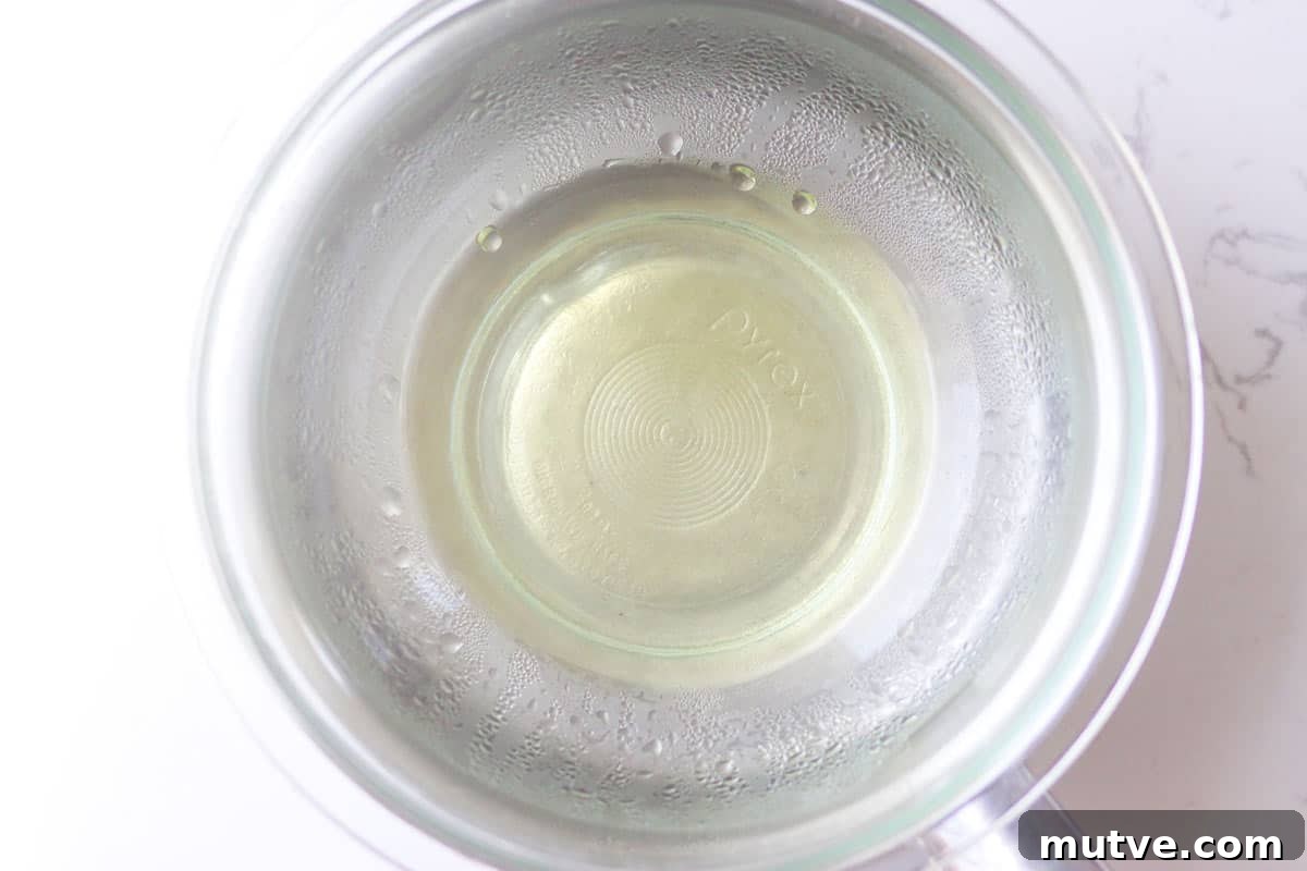 Beeswax Lip Balm Recipe: How to Make Soft, Hydrated Lips 5 a saucepan with melted beeswax in it