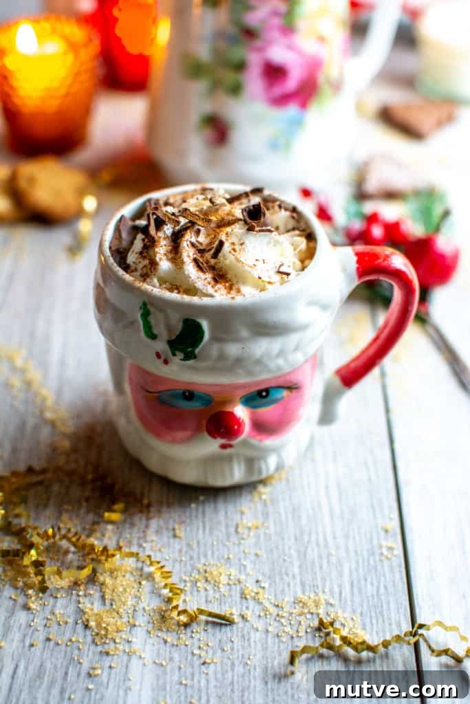 How to Make Mexican Mocha with Authentic Mexican Chocolate 5 A Santa mug filled with Mexican mocha on a table next to gold string
