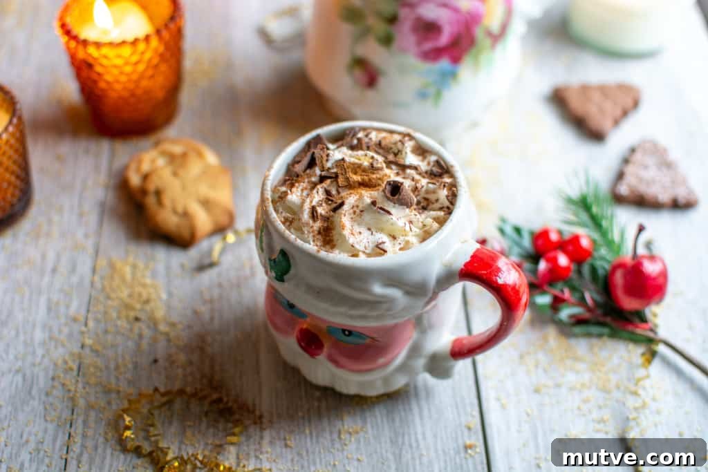 How to Make Mexican Mocha with Authentic Mexican Chocolate 8 A Santa mug with Mexican mocha in it and a candle behind it.