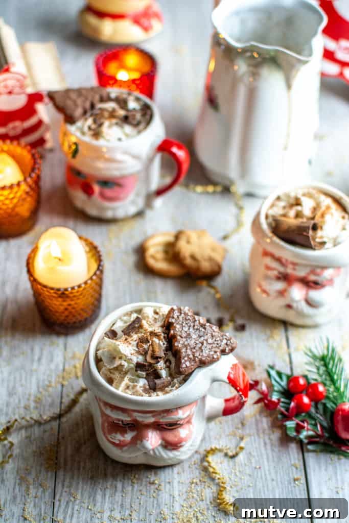 How to Make Mexican Mocha with Authentic Mexican Chocolate 9 Three Santa mugs with Mexican Mocha in them on a gray table.