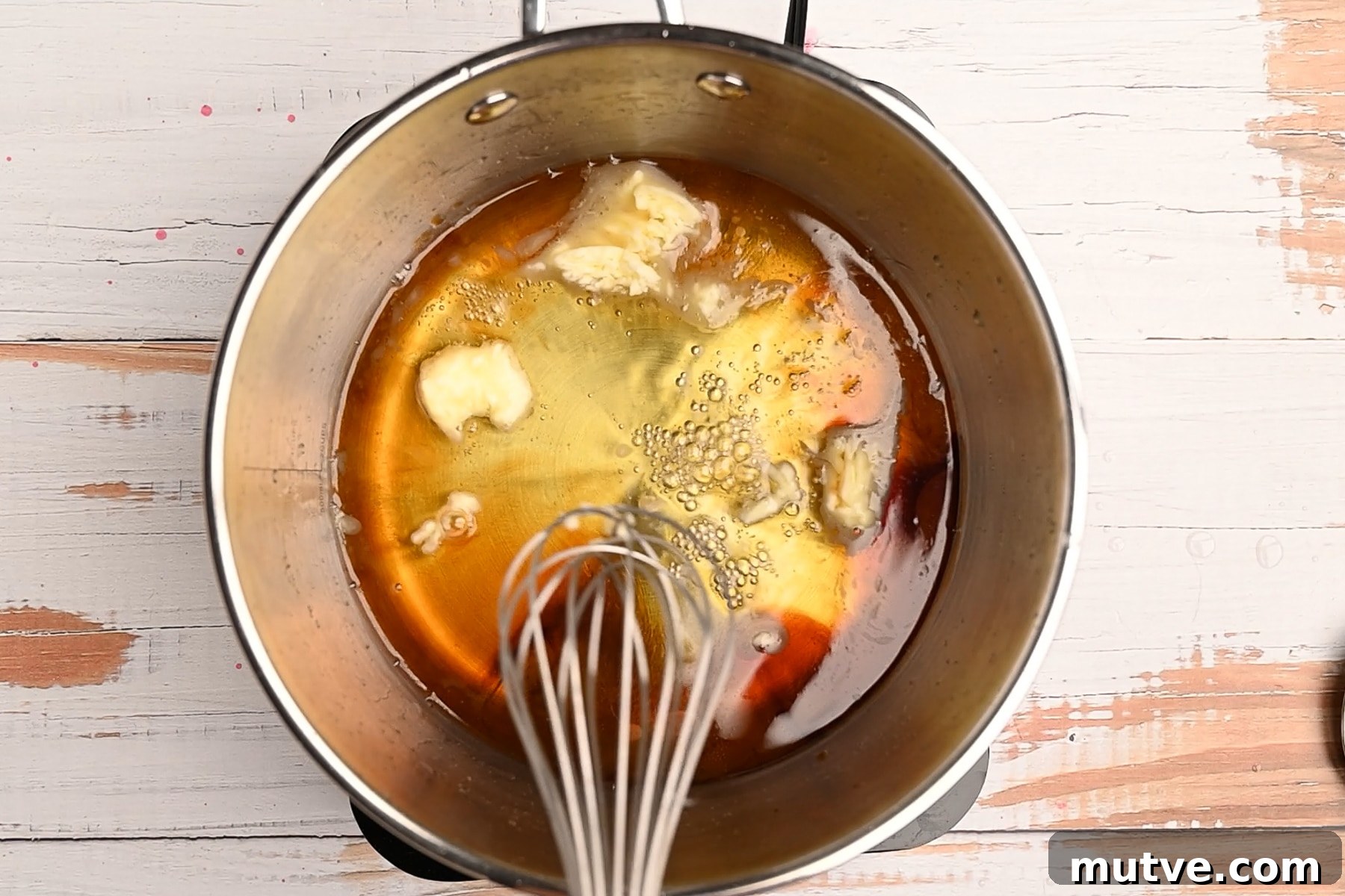 How to Make Keto Maple Syrup That Won't Crystallize 7 Butter being stirred into allulose mixture.