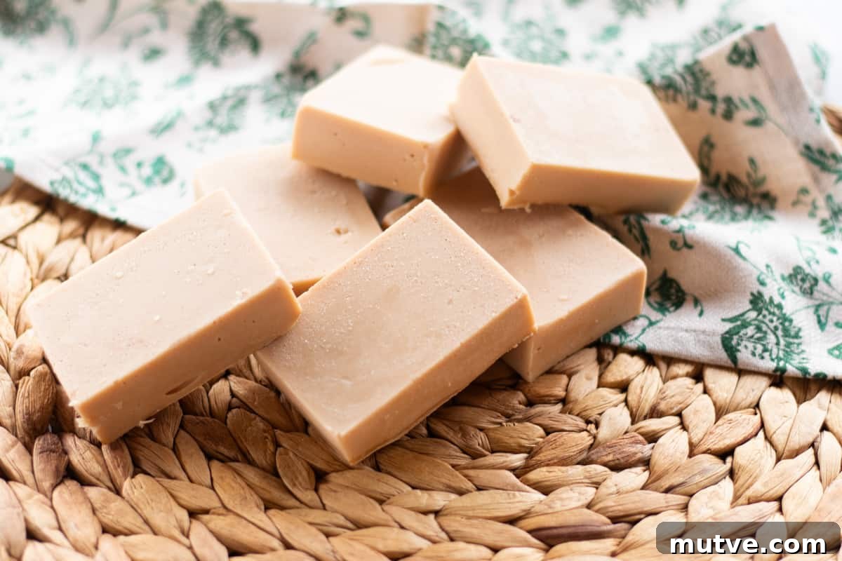 A pile of cold process soap bars on a wicker mat. 