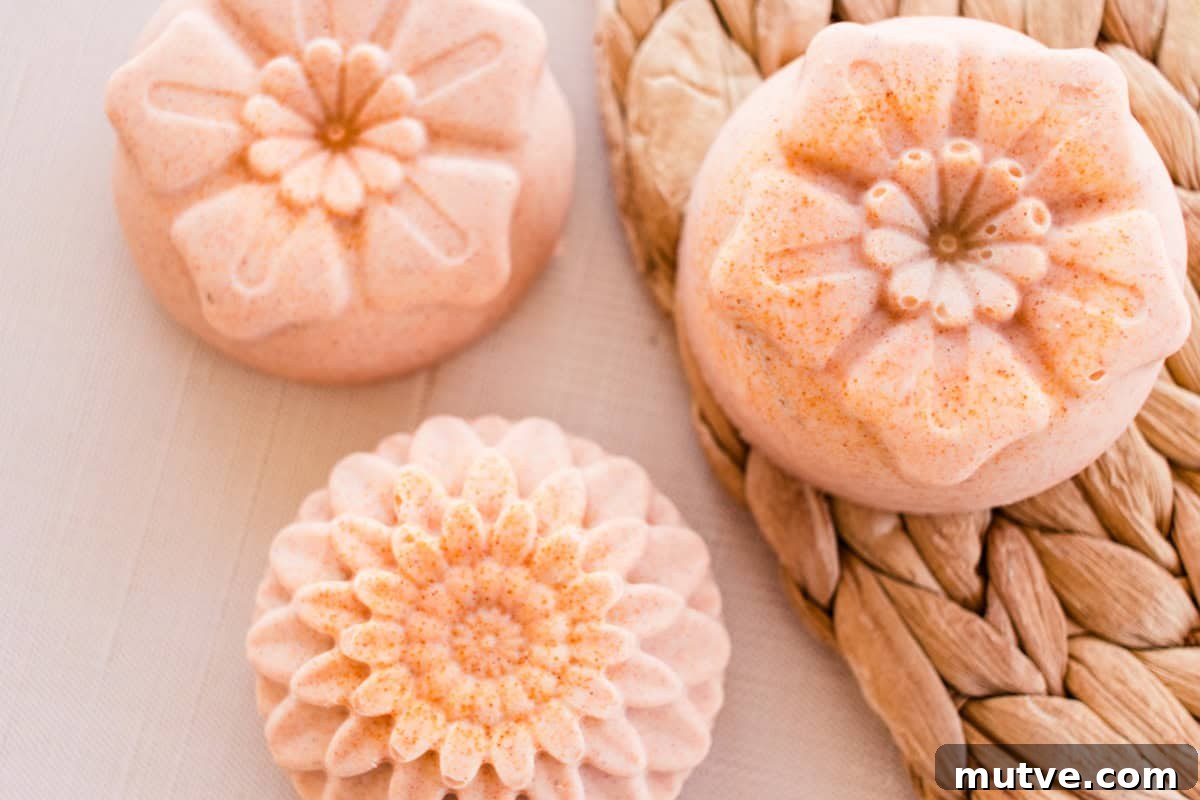 Flower-shaped orange soap bars on a wicker placemat.