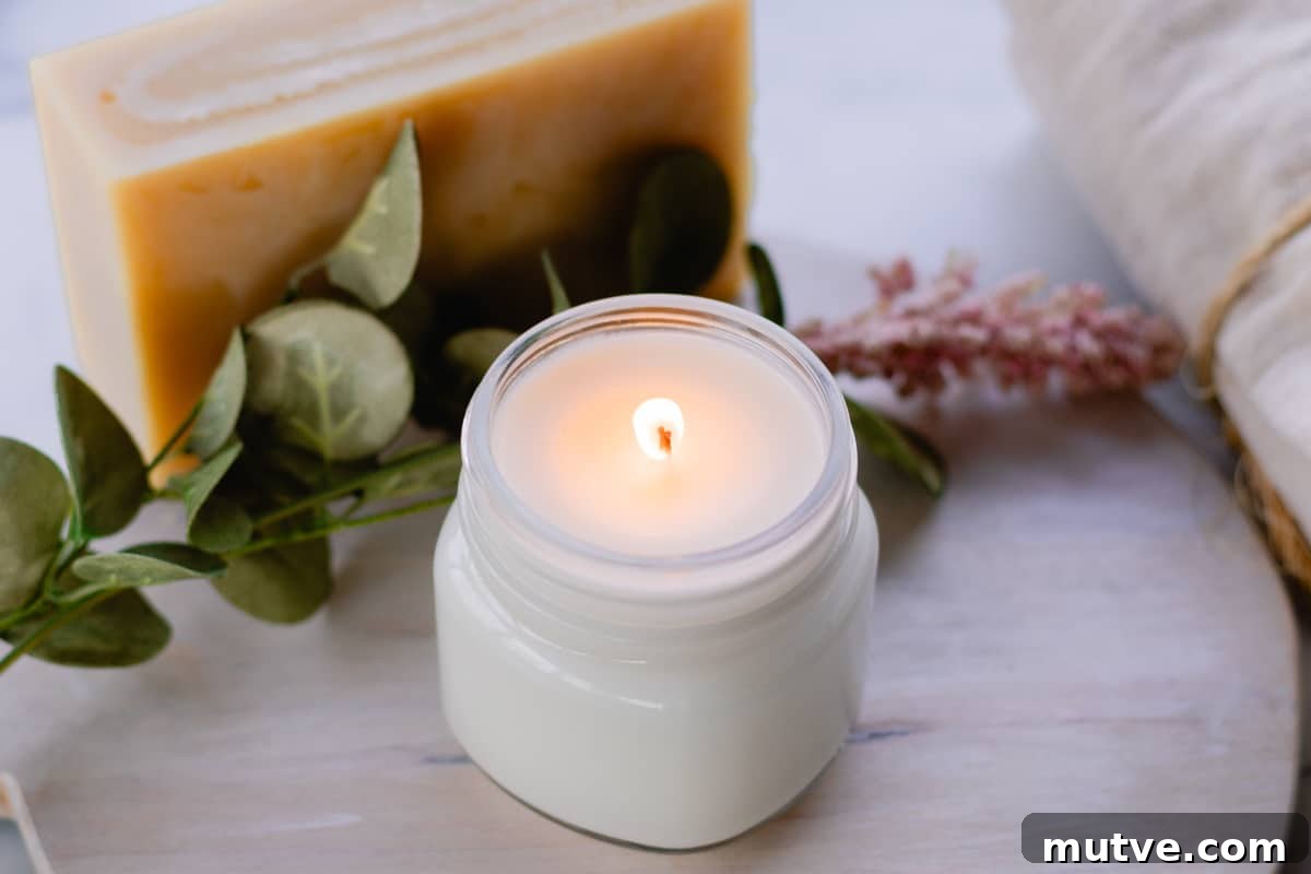 A lit soy candle in a glass jar. 