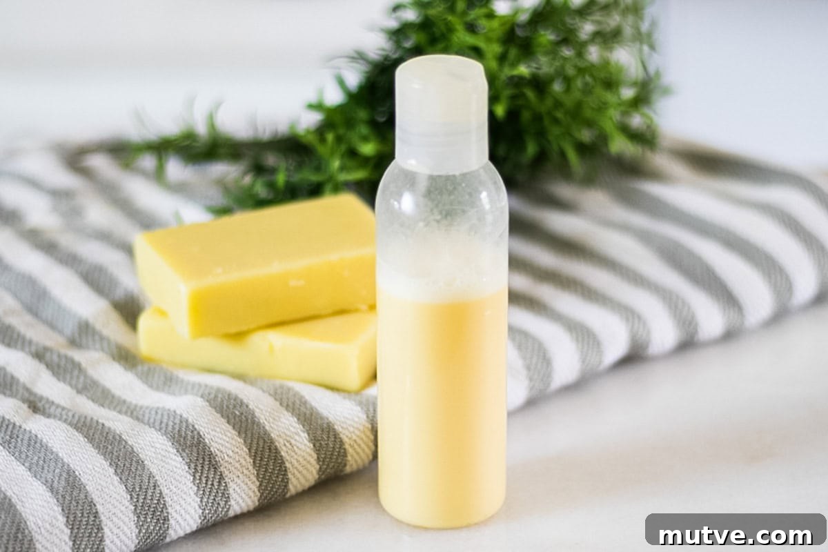 A bottle of homemade rosemary shampoo with a striped towel and soap bars.