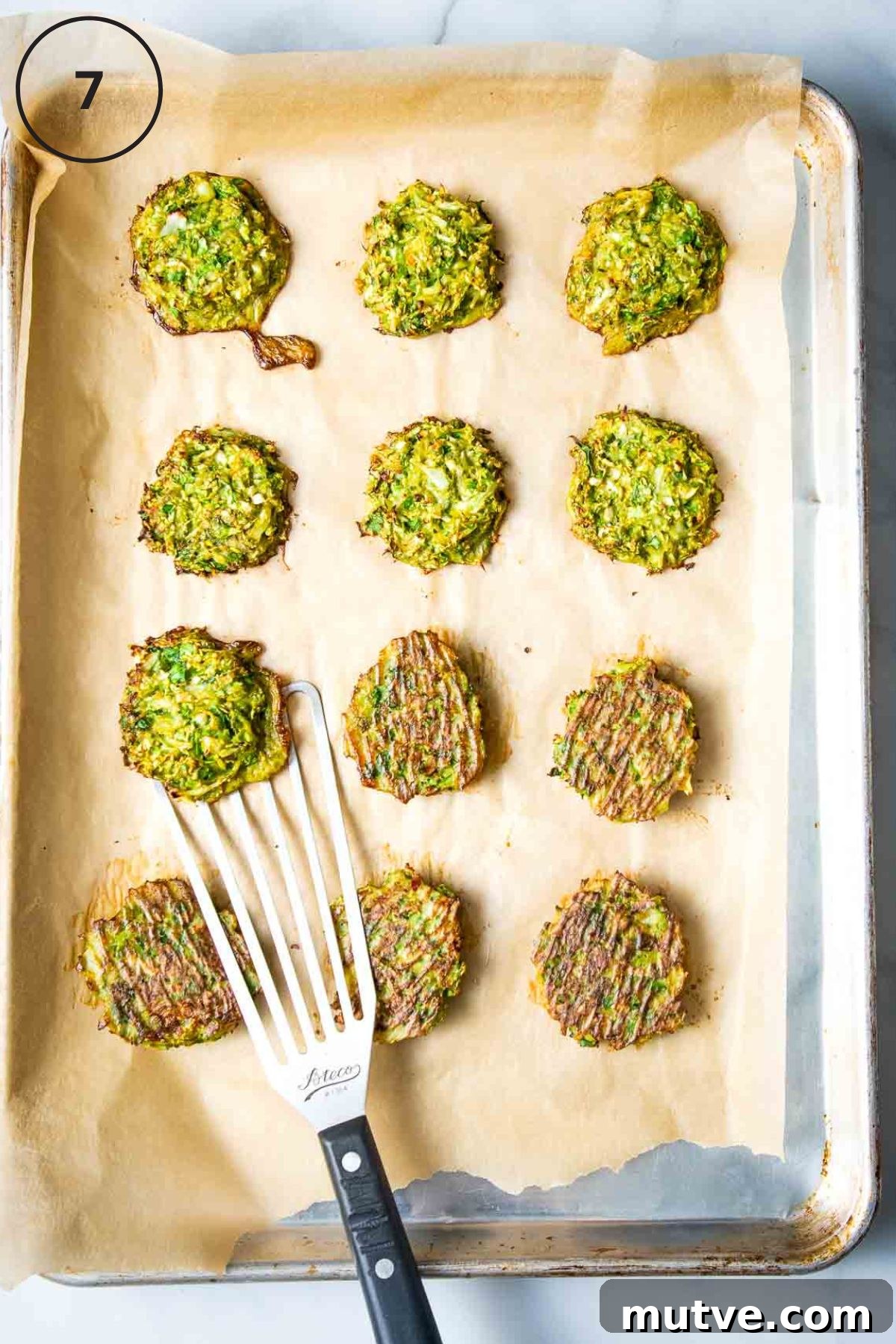 Crispy Oven Baked Brussels Sprouts Latkes 5 Flipping brussels sprouts latkes over on a tray lined with parchment.