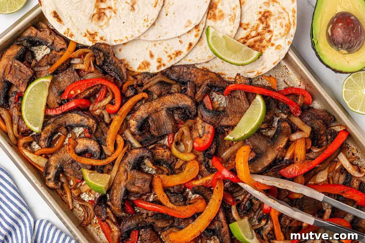 How to Make Portobello Mushroom Fajitas with Peppers and Onions 17 portobello mushroom fajita veggies on a sheet pan with flour tortillas