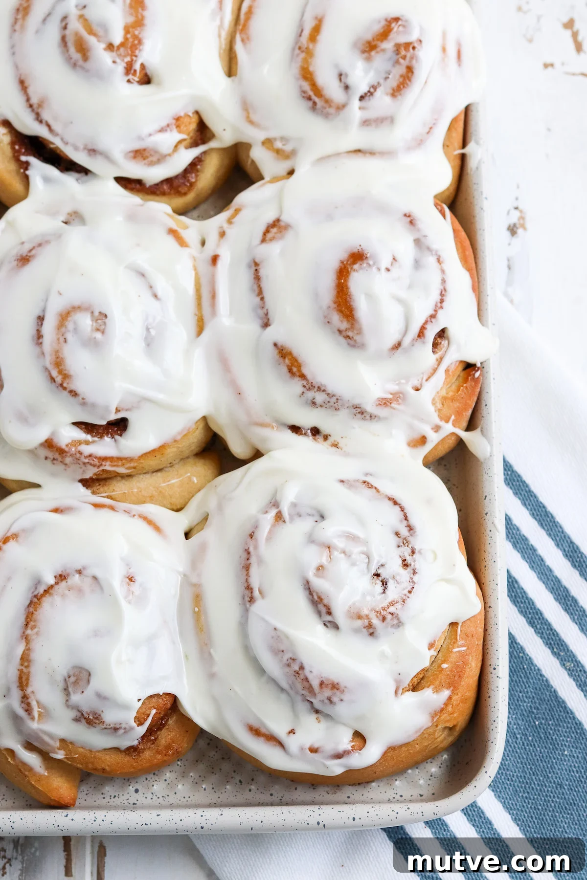 Homemade Whole-Wheat Cinnamon Rolls Recipe 2 up close of cinnamon roll with cream cheese frosting