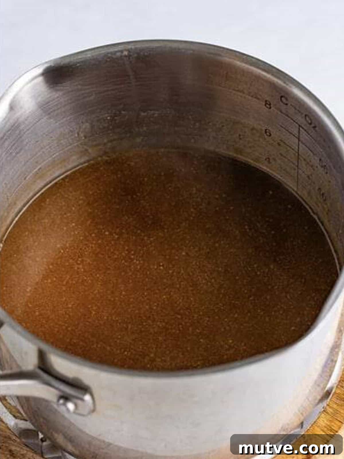 Slow Cooker Mississippi Meatloaf Recipe 15 Strained gravy simmering in a pot before thickening with cornstarch slurry.