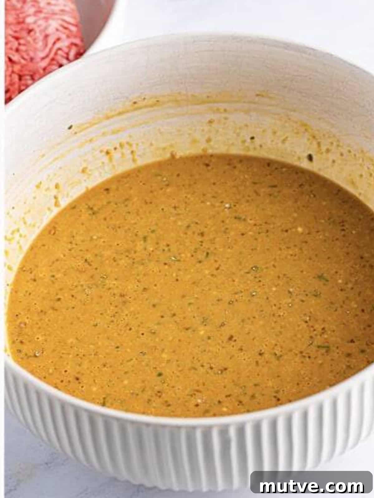 Slow Cooker Mississippi Meatloaf Recipe 5 Wet base whisked smooth in a white bowl for Mississippi crockpot meatloaf.