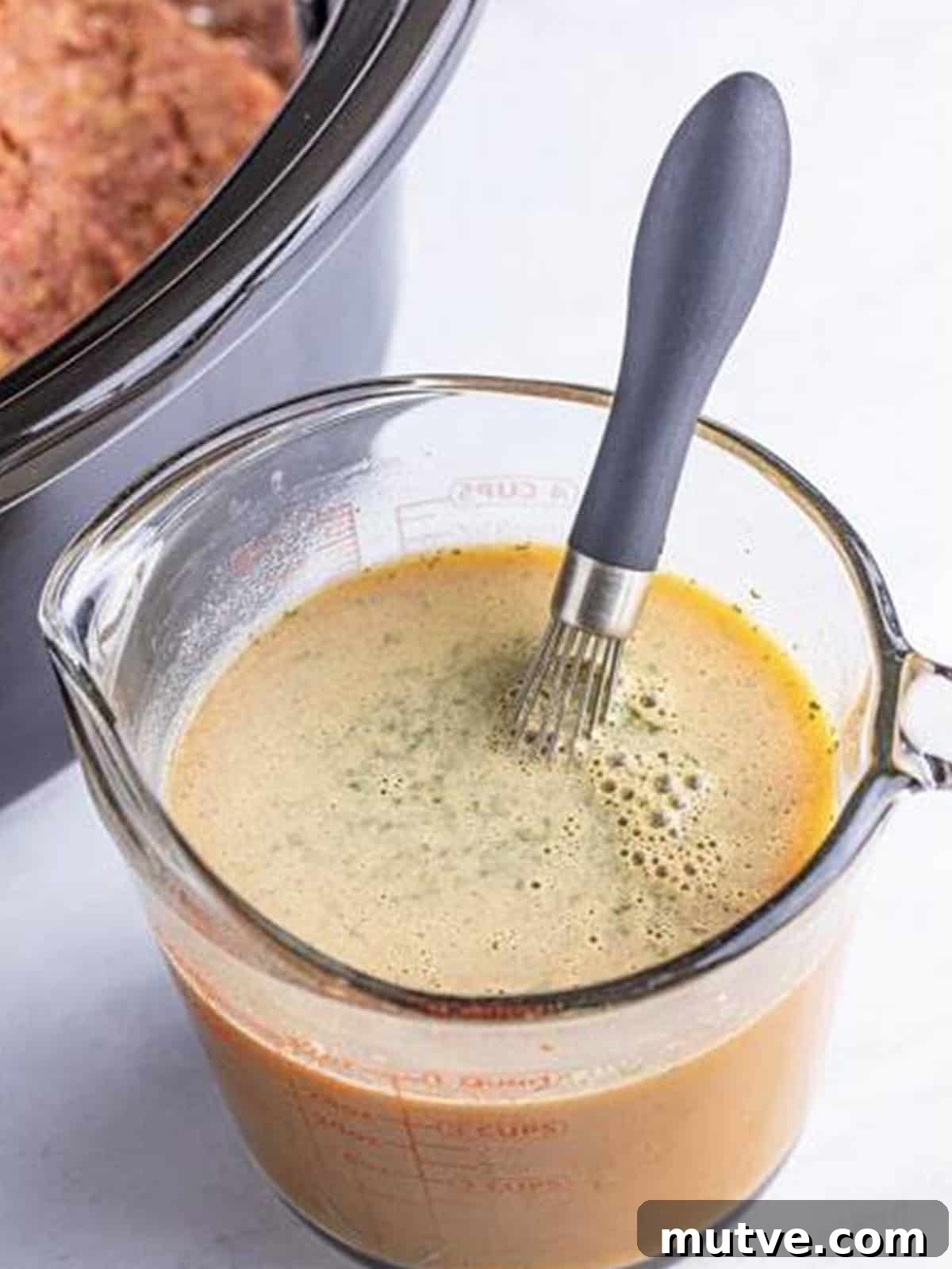 Slow Cooker Mississippi Meatloaf Recipe 10 Mississippi gravy whisked together in a measuring cup with au jus and ranch packets.