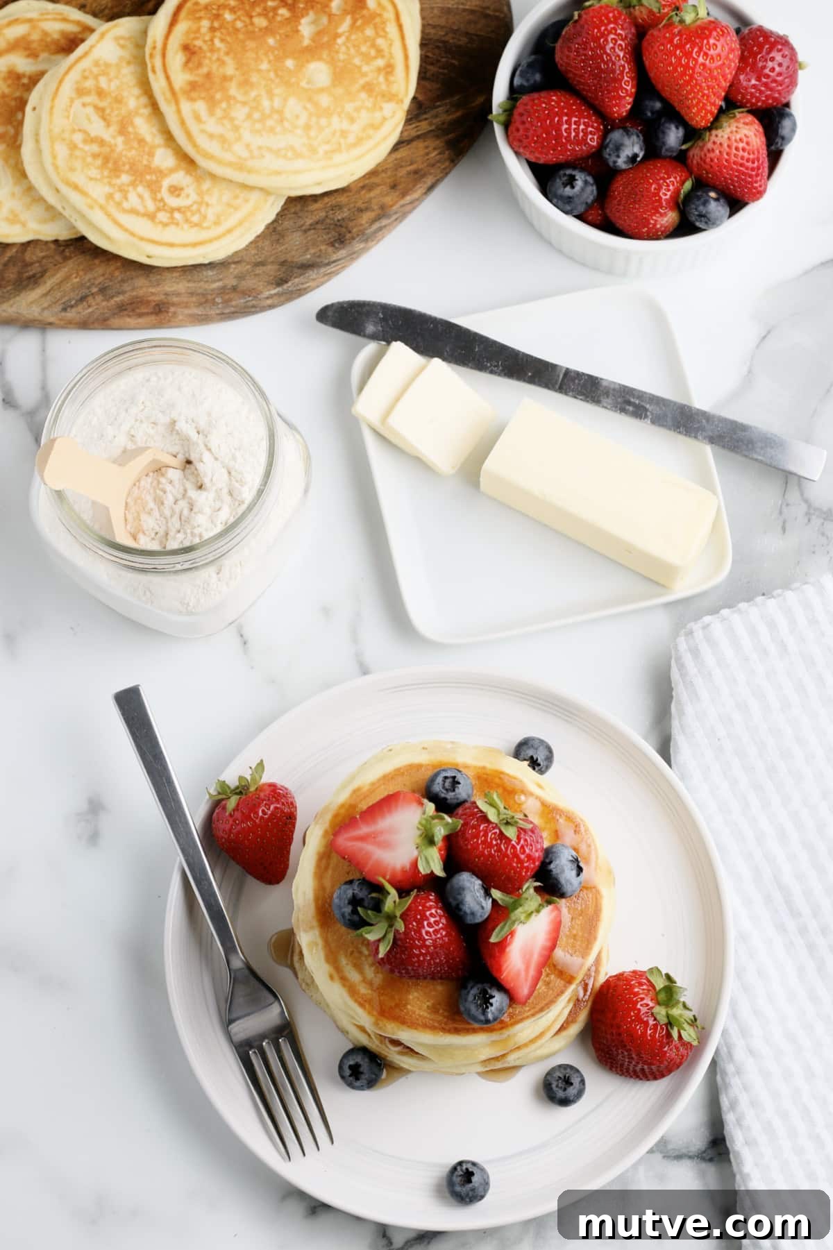 Bisquick Pancake Recipe: Fluffy, Light and Quick 2 a breakfast spread with pancakes butter and fruit