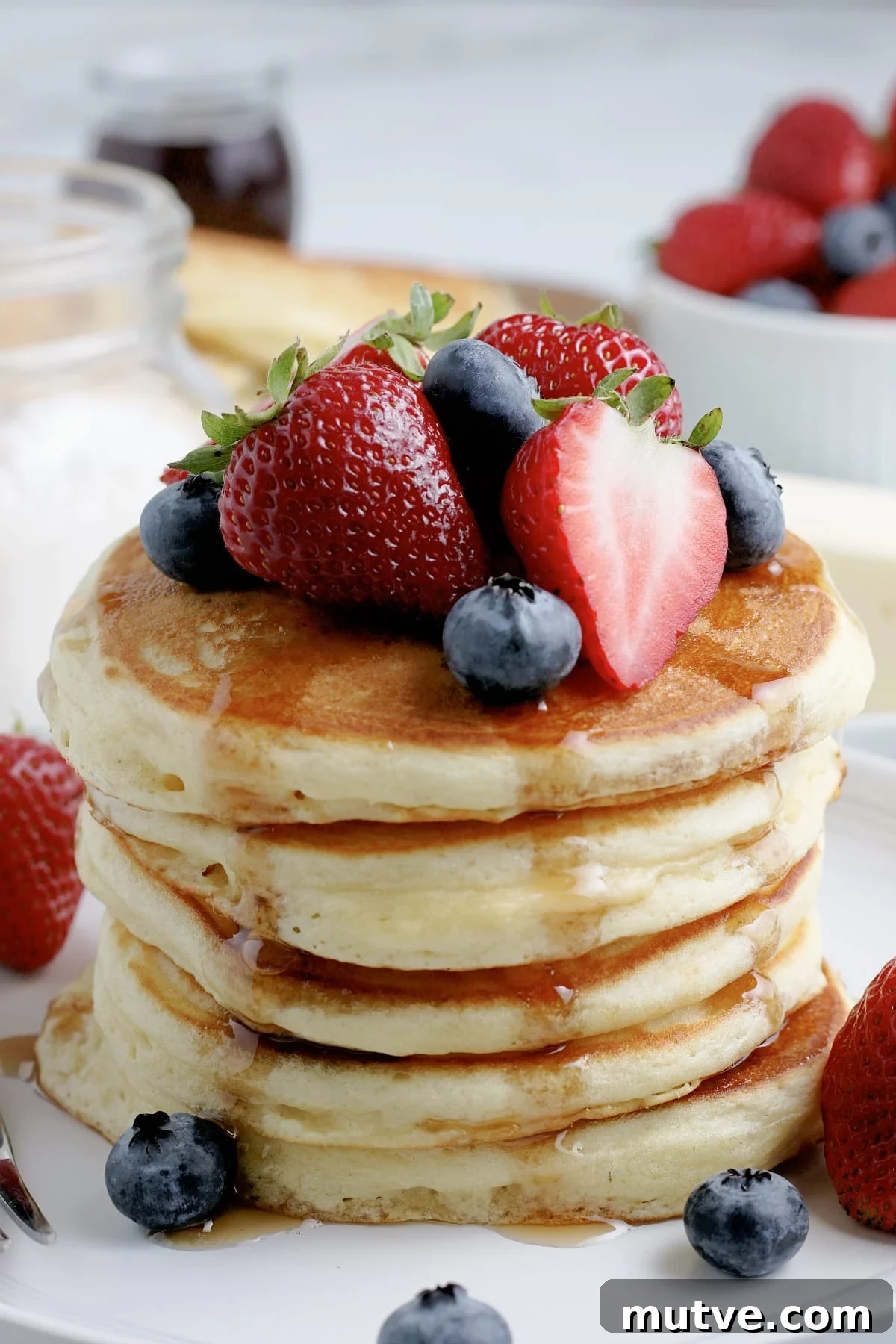 Bisquick Pancake Recipe: Fluffy, Light and Quick 3 stack of pancakes with syrup and fruit
