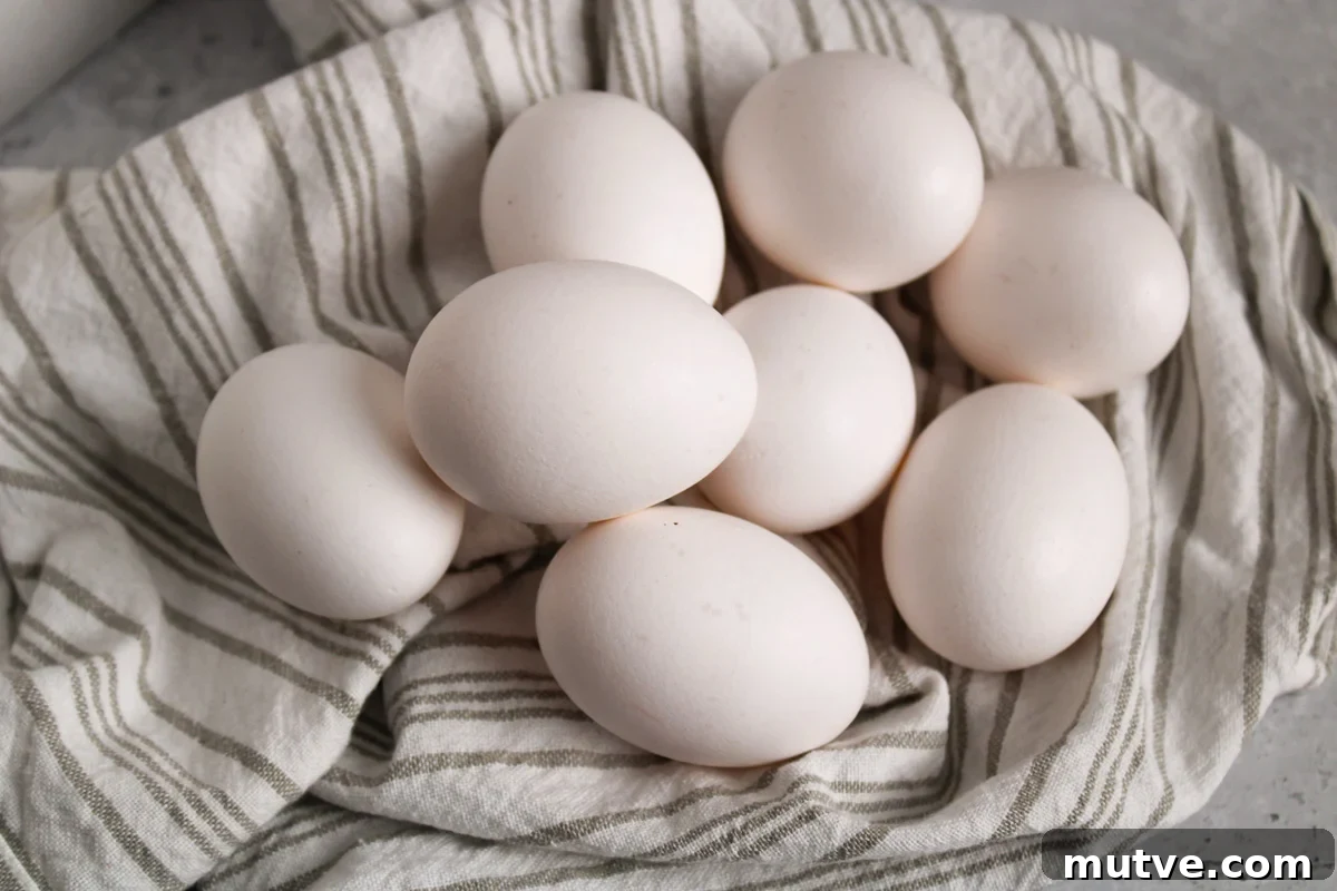 How to Make Air Fryer Eggs: Fluffy, Hands-Off Breakfast 3 Pile of raw eggs on a towel.