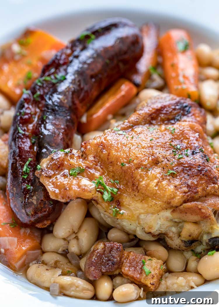 This comforting French Cassoulet recipe has juicy chicken, sausage, bacon and white beans that simmer away in a broth spiked with onion, garlic and herbs. roasted sausage and chicken with white beans