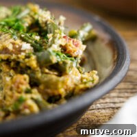 Close up of smoked green bean casserole on a plate, loaded with bacon and mushrooms.