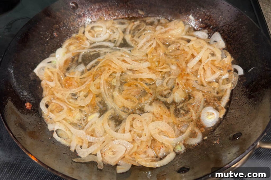 Sauteing onions in a fry pan.